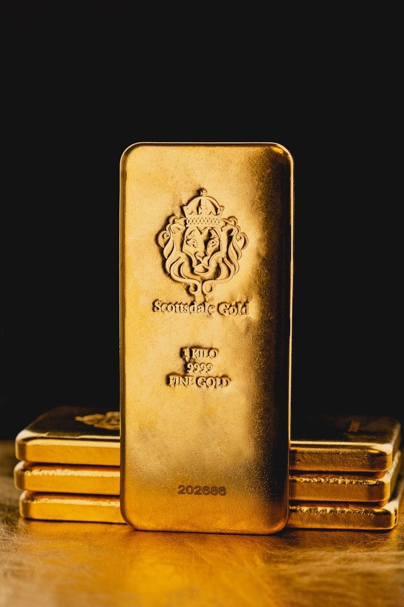 a stack of gold bars sitting on top of a wooden table