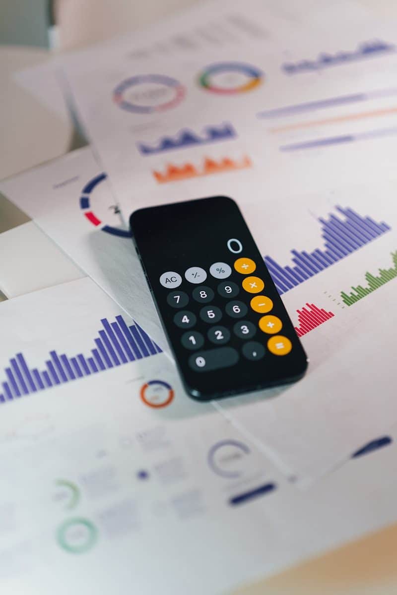 smartphone calculator app on financial report papers
