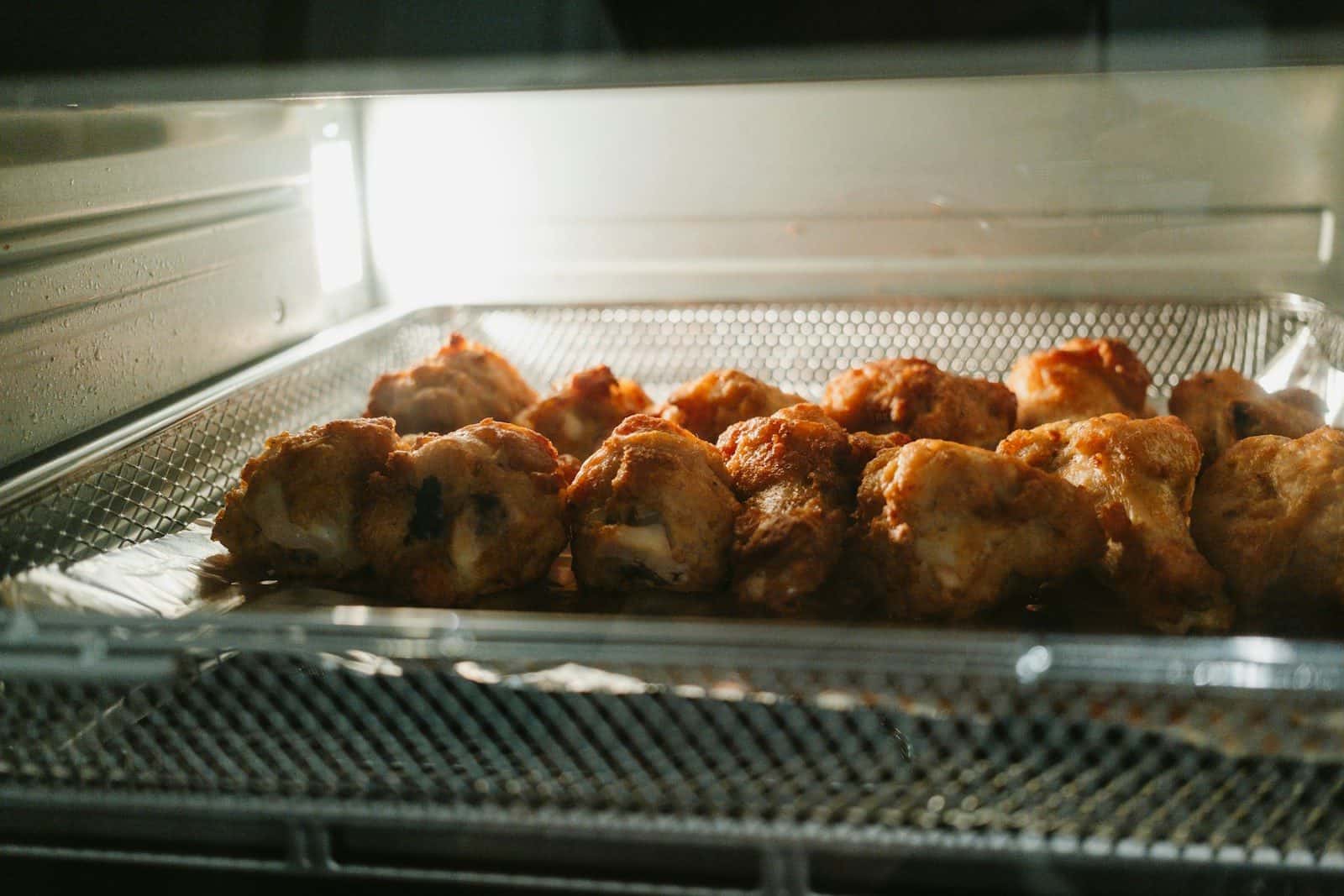 Golden brown pieces of food baking inside an oven.