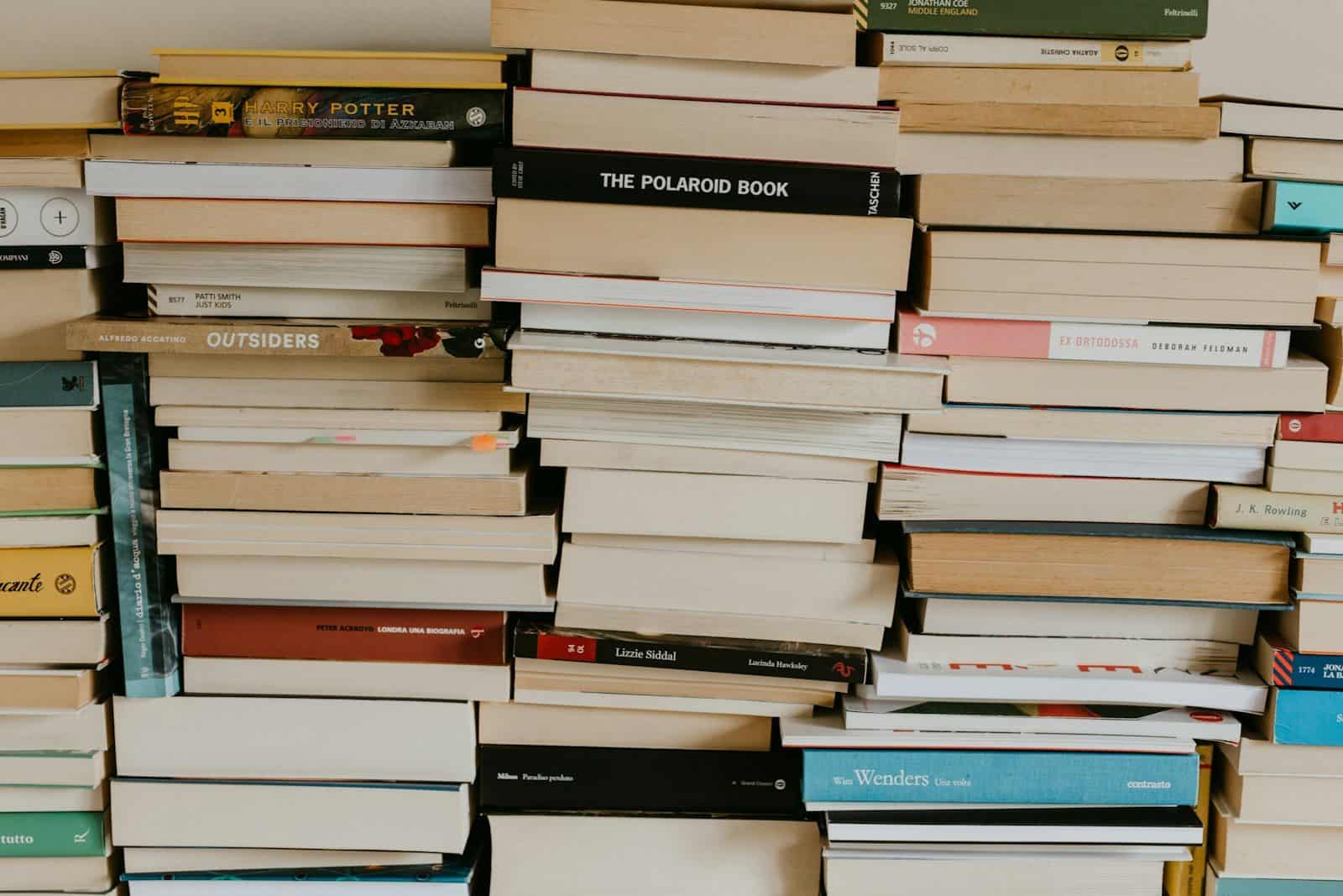 a pile of books sitting on top of a wall