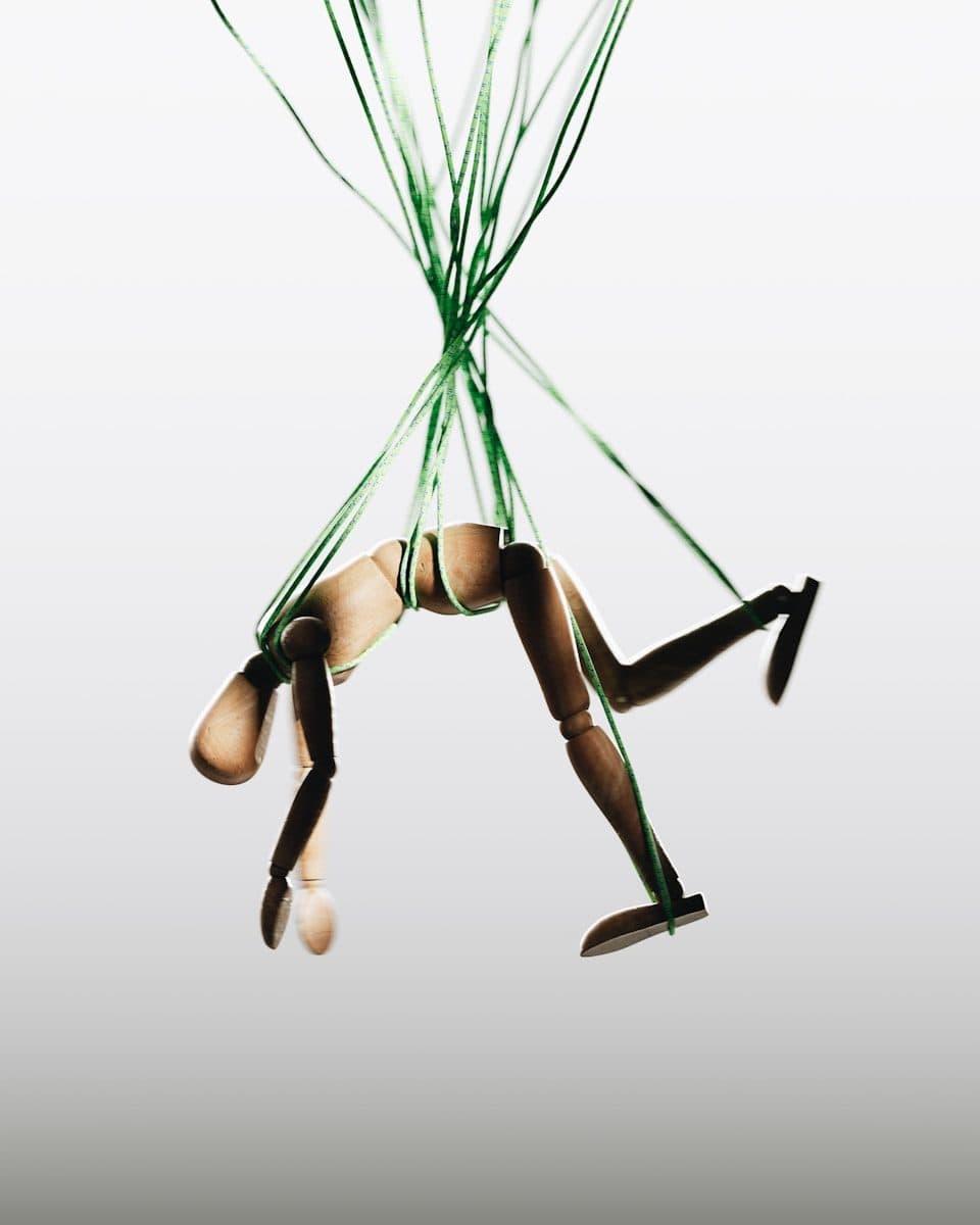 a woman in a tight bodysuit is suspended in the air