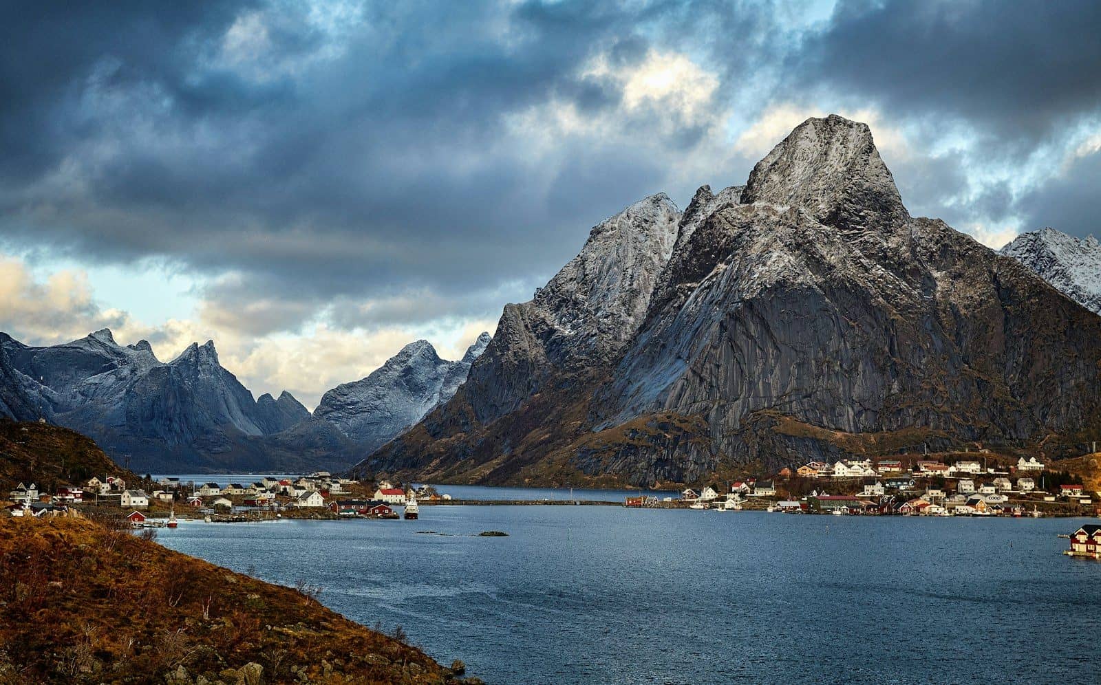 A village with red houses on the coast of Reine in Lofoten, Norway