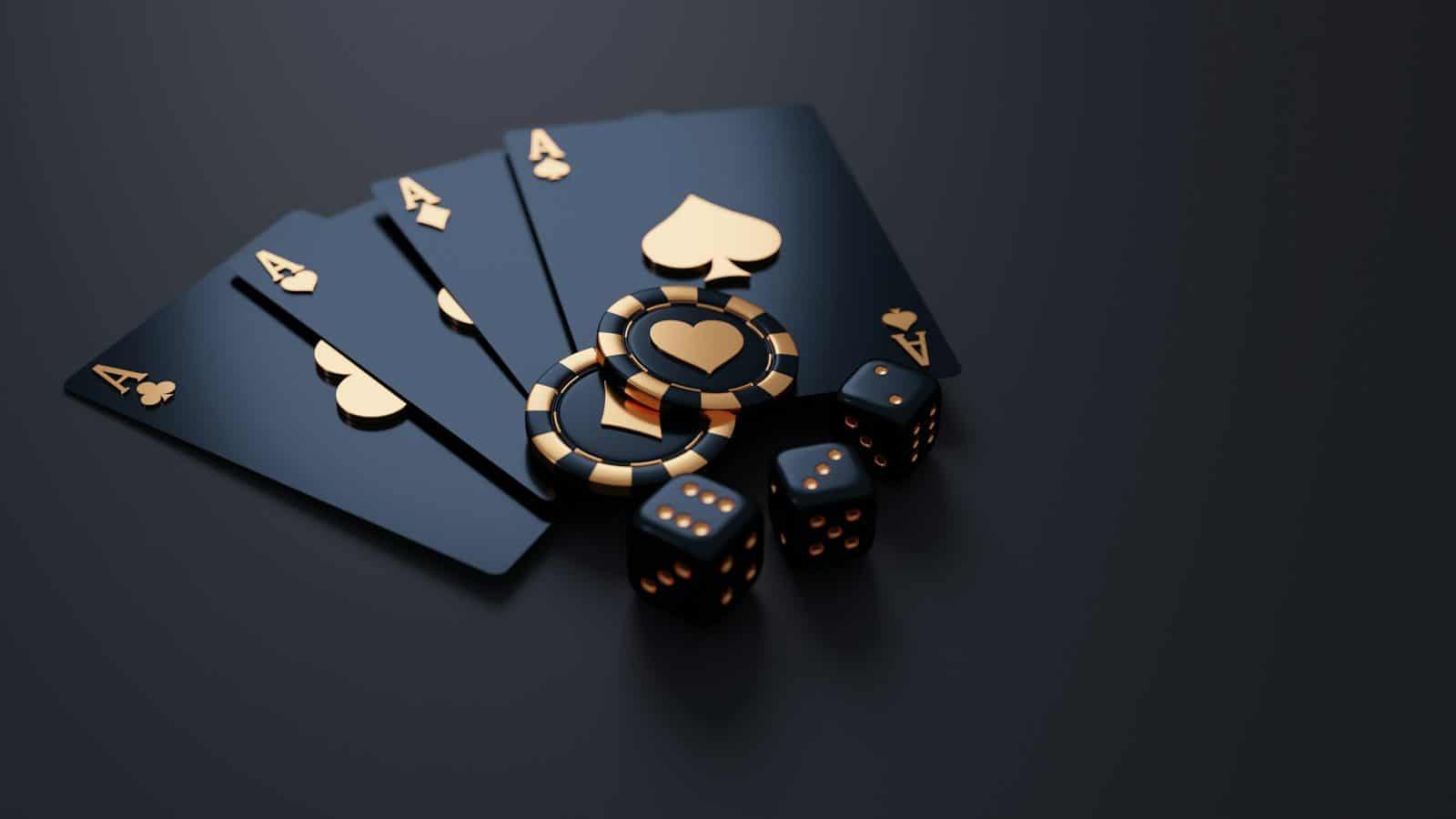 Black playing cards with gold aces, poker chips, and dice on dark surface