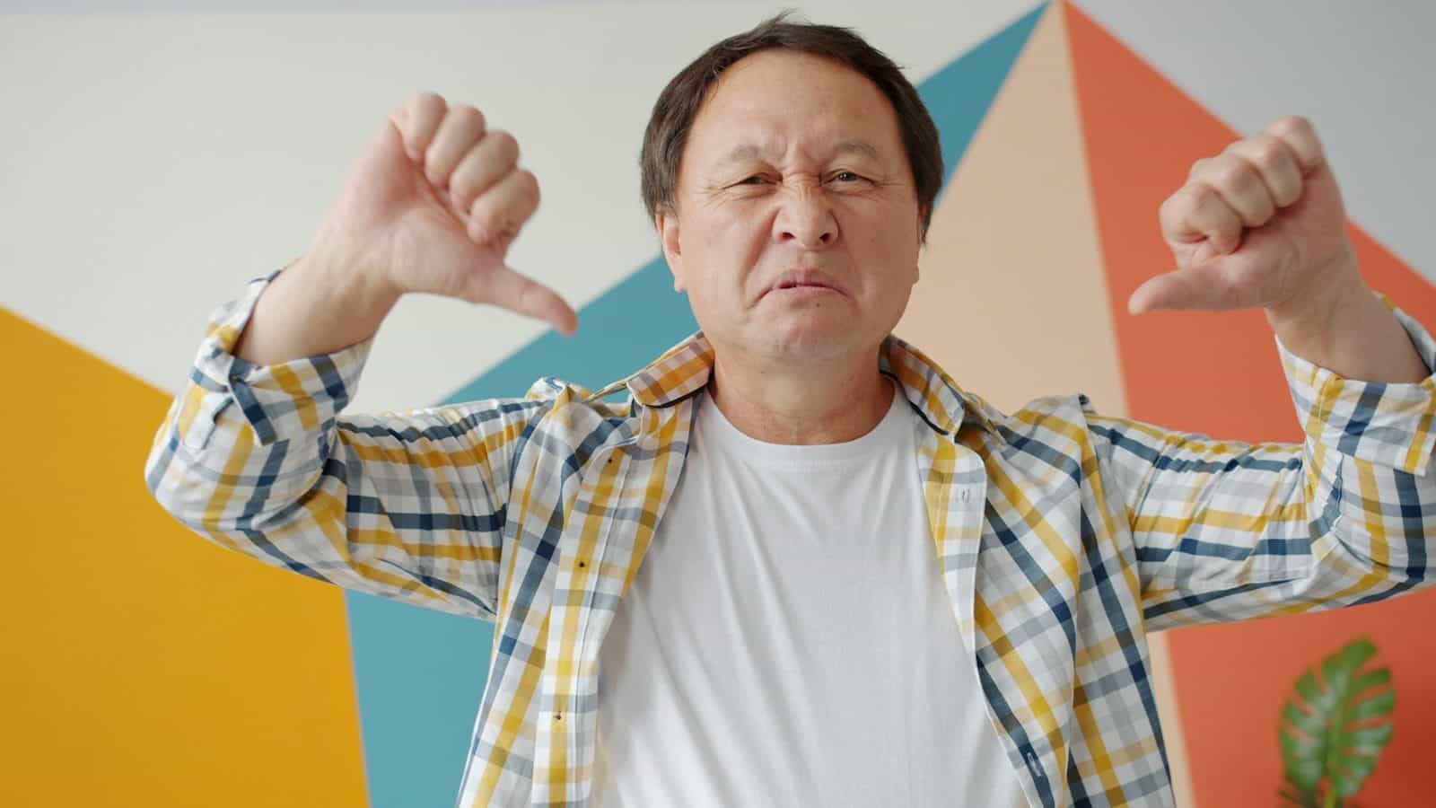 Man giving two thumbs down gesture