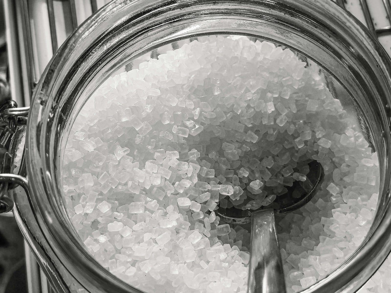Close-up of coarse salt crystals in a glass jar