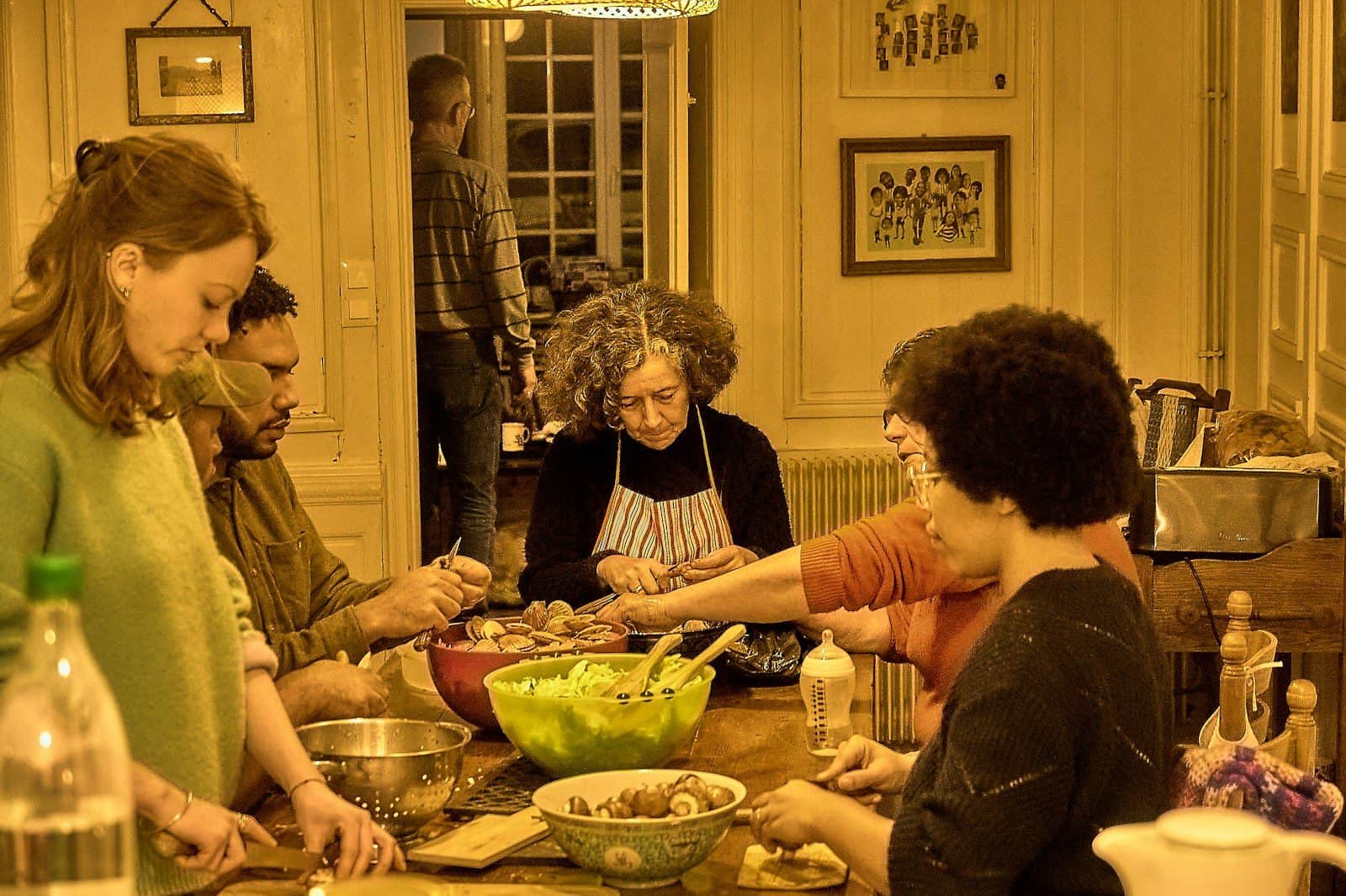 People gathered around a table preparing food together