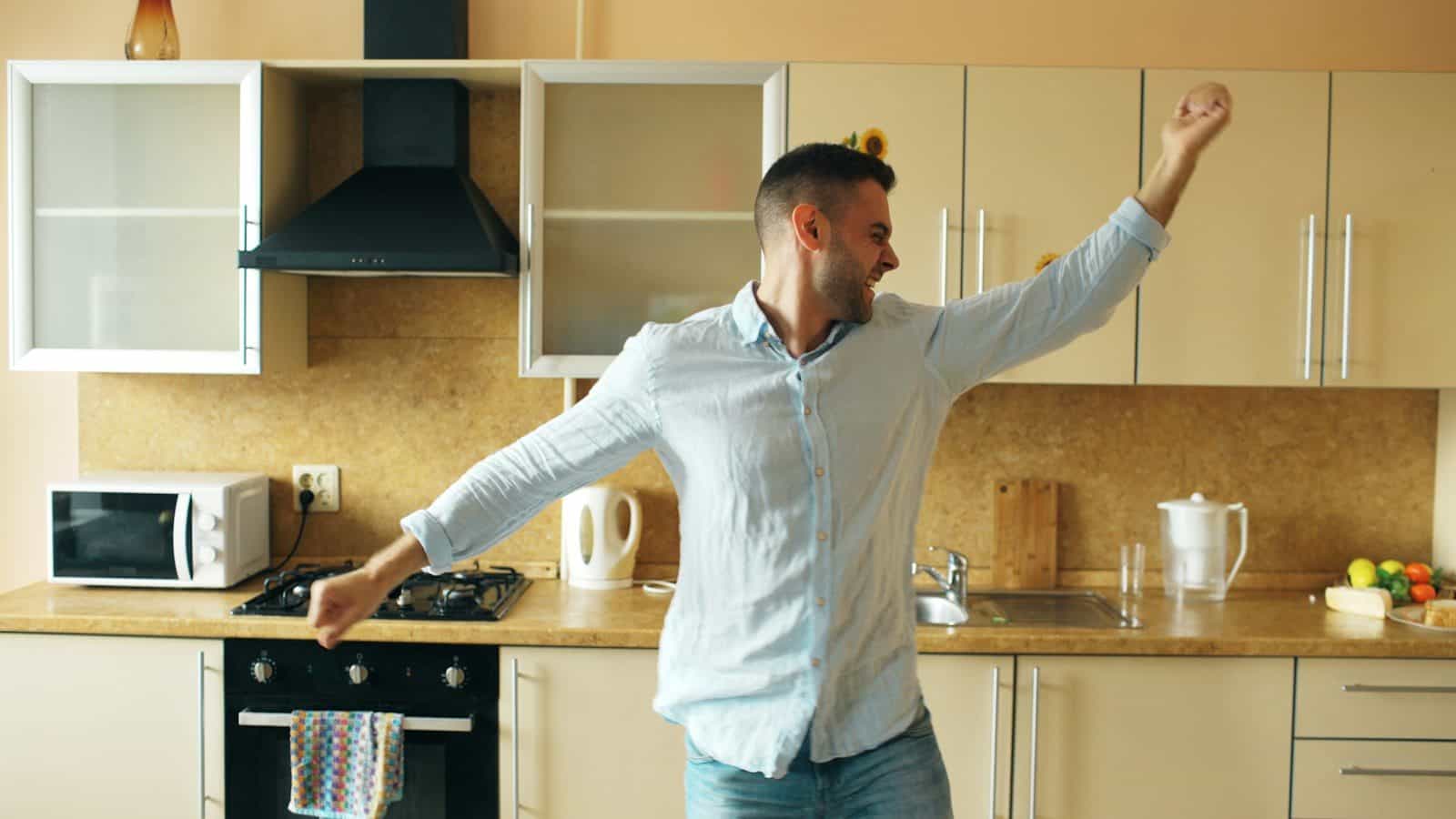 Man dancing happily in a modern kitchen