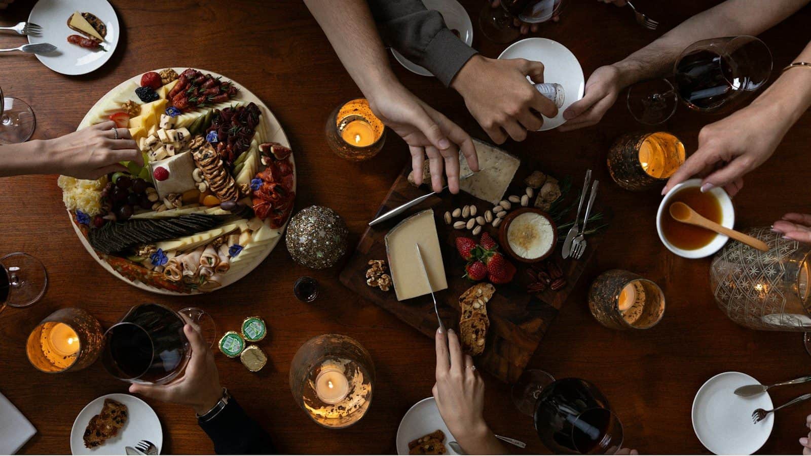 People gathered around a table with a charcuterie board
