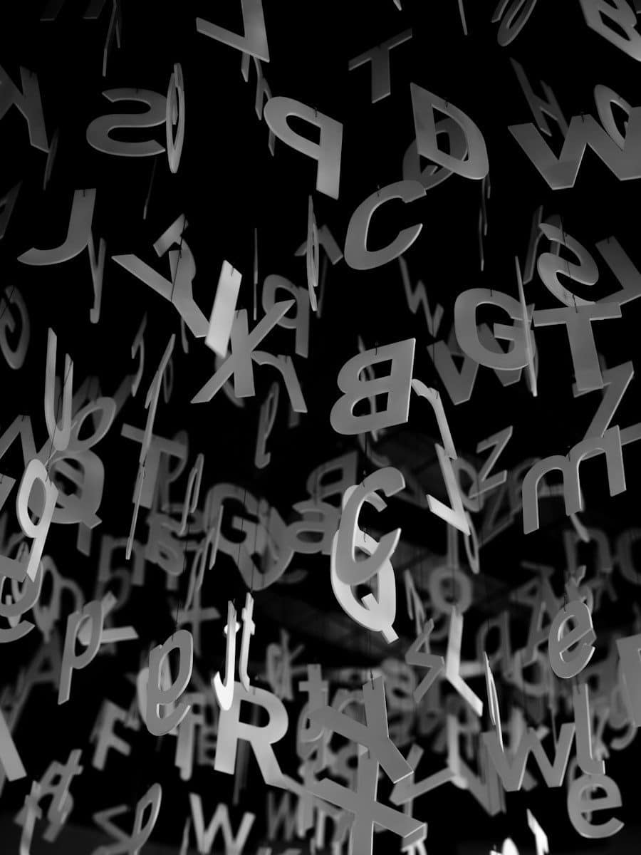 Many letters of the alphabet hanging against a black background